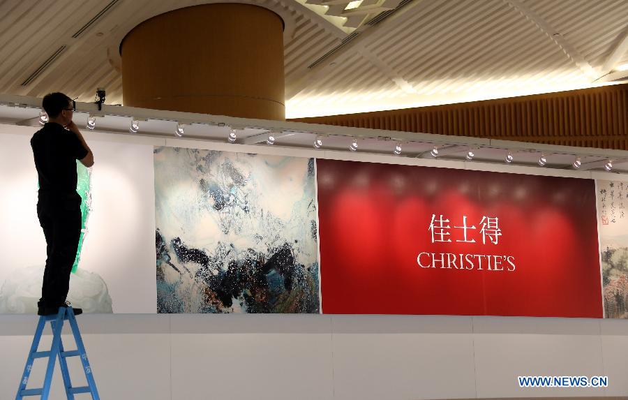 A staff member prepares for the Christie's 2013 spring auctions in south China's Hong Kong, May 24, 2013. The five-day auctions begin on May 25. (Xinhua/Li Peng) 