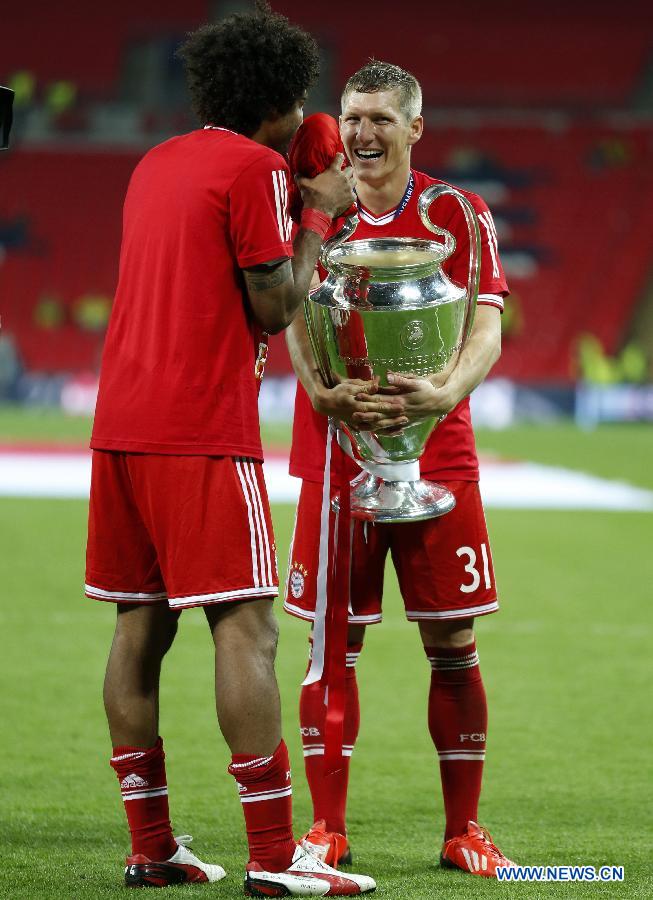 Bastian Schweinsteiger of Bayern Munich (R)celebrates after the awarding ceremony for the UEFA Champions League final football match between Borussia Dortmund and Bayern Munich at Wembley Stadium in London, Britain on May 25, 2013. Bayern Munich claimed the title with 2-1.(Xinhua/Wang Lili)