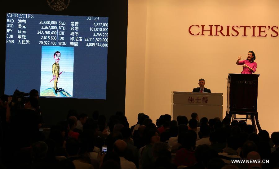 An auctioneer auctions a painting work by Chinese painter Zeng Fanzhi at an auction of the Asian 20th Century & Contemporary Art held by Christie's in Hong Kong, south China, May 25, 2013. The five-day Christie's 2013 spring auctions kicked off in Hong Kong on May 25. (Xinhua/Li Peng)