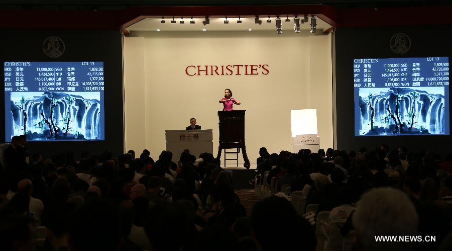 An auctioneer auctions a painting work by late Chinese painter Wu Guanzhong at an auction of the Asian 20th Century & Contemporary Art held by Christie's in Hong Kong, south China, May 25, 2013. The five-day Christie's 2013 spring auctions kicked off in Hong Kong on May 25. (Xinhua/Li Peng)