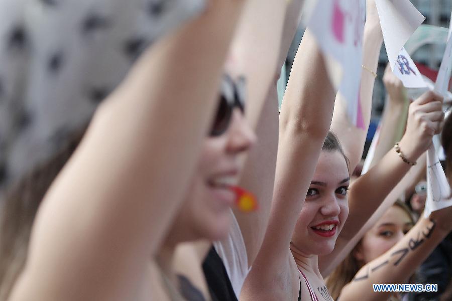 Activists take part in the "SlutWalk" in Sao Paulo, Brazil on May 25, 2013. The event was held to protest any form of sexual harassment of any gender in public places among other issues. "SlutWalk" protests originated in Toronto, Canada, where they were sparked by a police officer's remark that women could avoid being raped by not dressing like "sluts". (Xinhua/Rahel Patrasso)