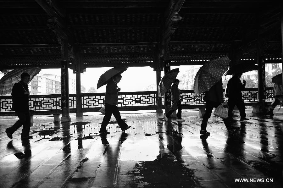 Pedestrians walk on a veranda bridge in Xuan'en County, central China's Hubei Province, May 25, 2013. Veranda bridge is a typical architecture of China's Dong ethnic group in south China. (Xinhua/Song Wen)  