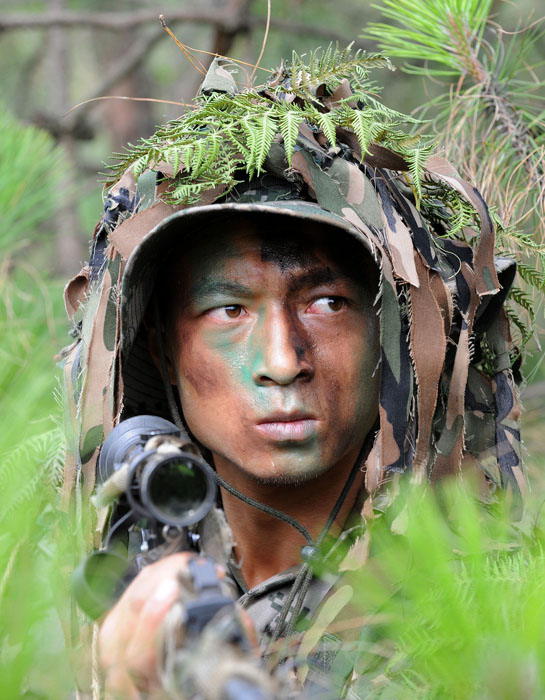 A sniper is in training. More than 200 snipers from the Chinese People's Liberation Army (PLA) concluded a 40-day training assembly on May 22, 2013. The training ended with a multi-subject shooting and sniping drill in Kunming, capital of southwest China's Yunnan province. (Xinhua Photo/ Wu Sulin)