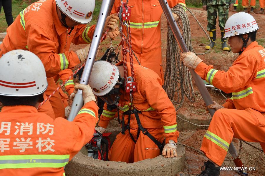 Firefighters participate in a rescue drill in Malong County of Qujing City, southwest China's Yunnan Province, May 25, 2013. A total of 116 firefighters attended the rescue drill for earthquake emergencies. (Xinhua/Hou Wenkun)