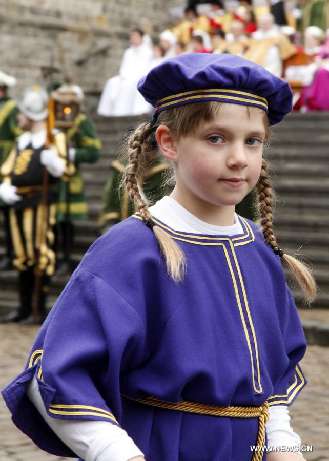 A girl in mediaeval style dresses attends the Ducasse de Mons or Doudou celebration in Mons, Belgium, May 26, 2013. The popular festival, originating in the Middle Ages and depicting the combat between Saint George and a dragon, is recognized by UNESCO as one of the Masterpieces of the Oral and Intangible Heritage of Humanity. (Xinhua/Wang Xiaojun) 