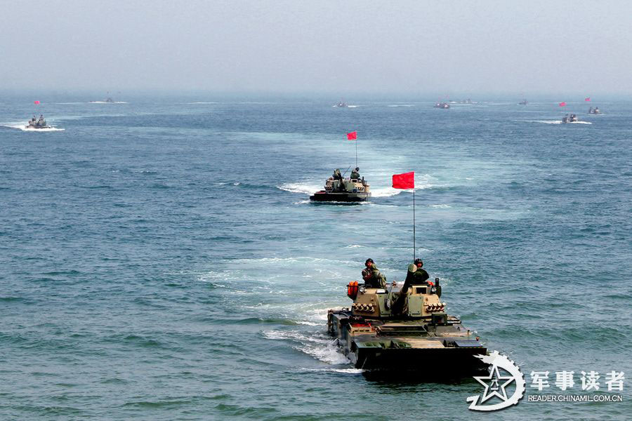 An amphibious armored brigade under the Nanjing Military Area Command (MAC) of the Chinese People's Liberation Army (PLA) takes its troops to unfamiliar area on May 26, 2013 to conduct live-ammunition firing training. (China Military Online/Jiang Jiangao)