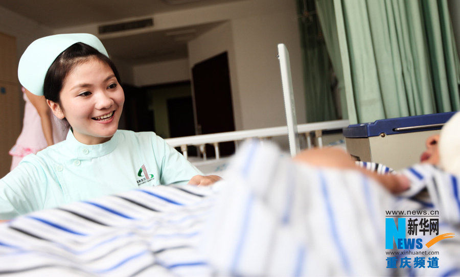 Zhao Xiaofan, born 10 1990, is a nurse in Chongqiing South West Hospital. Her smile brings warmth to a lot of patients. (Xinhua/Peng Bo)