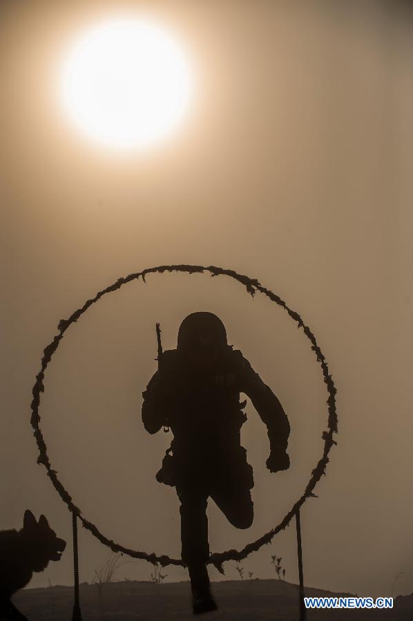 A member of SWAT (Special Weapons and Tactics) team receives training in the Jingning She Autonomous County, east China's Zhejiang Province, May 28, 2013. (Xinhua/Li Suren)