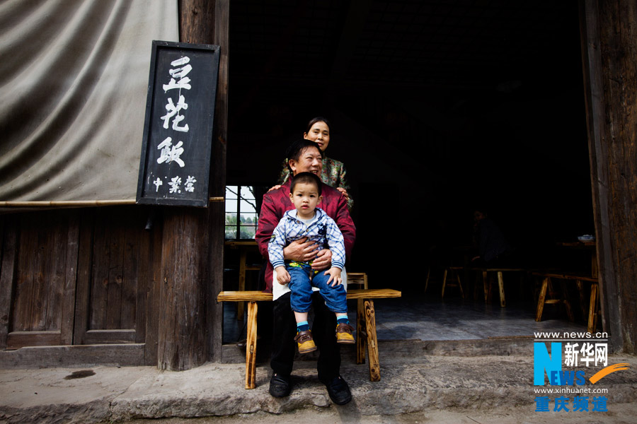The boss of a tofu pudding shop, his wife and grandson.(Xinhua/Peng Bo)