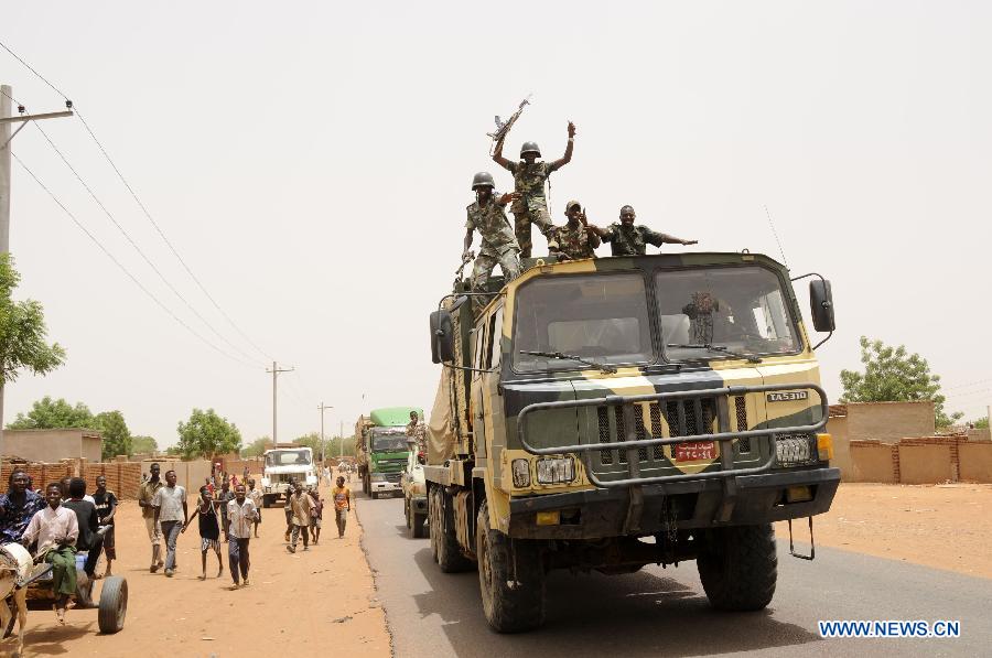 Soldiers wave to residents after returning from battlefield, in El Rahad of Sudan's North Kordofan State May 28, 2013. Sudanese army announced on Monday that it has liberated the strategic area of Abu Karshula in South Kordofan State from rebels of the Revolutionary Front. (Xinhua/Mohammed Babiker)