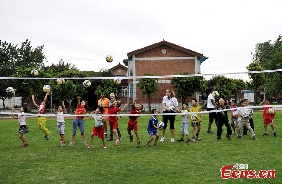 Three former U.S. national team members, as part of a Sports Delegation selected by the U.S. Department of State, play volleyball with students at SOS Children's Village in Chengdu, capital of southwest China's Sichuan Province, May 28, 2013. (CNS/An Yuan)