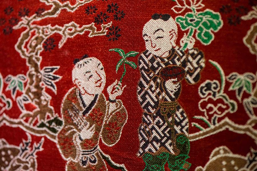 Photo taken on May 27, 2013 shows part of an artwork of Shu brocade, in Chengdu, capital of southwest China's Sichuan Province. Imparted from generation to generation for over 2,000 years, Shu brocade weaving techniques have been put on China's Intangible Cultural Heritage List in 2006. (Xinhua/Li Qiaoqiao) 