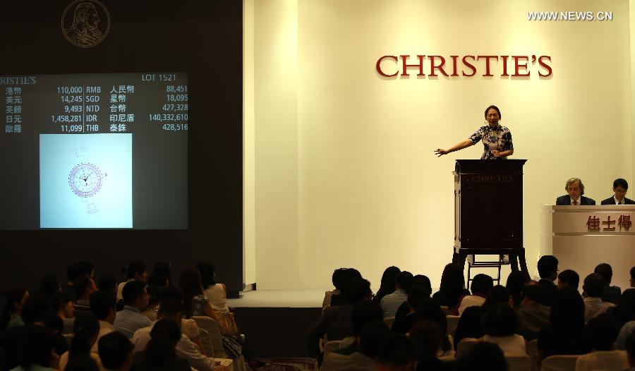 An auctioneer presides over an auction of the Asian 20th Century & Contemporary Art held by Christie's in Hong Kong, south China, May 28, 2013. The five-day Christie's 2013 Spring auctions kicked off in Hong Kong on May 25 this year. (Xinhua/Li Peng)