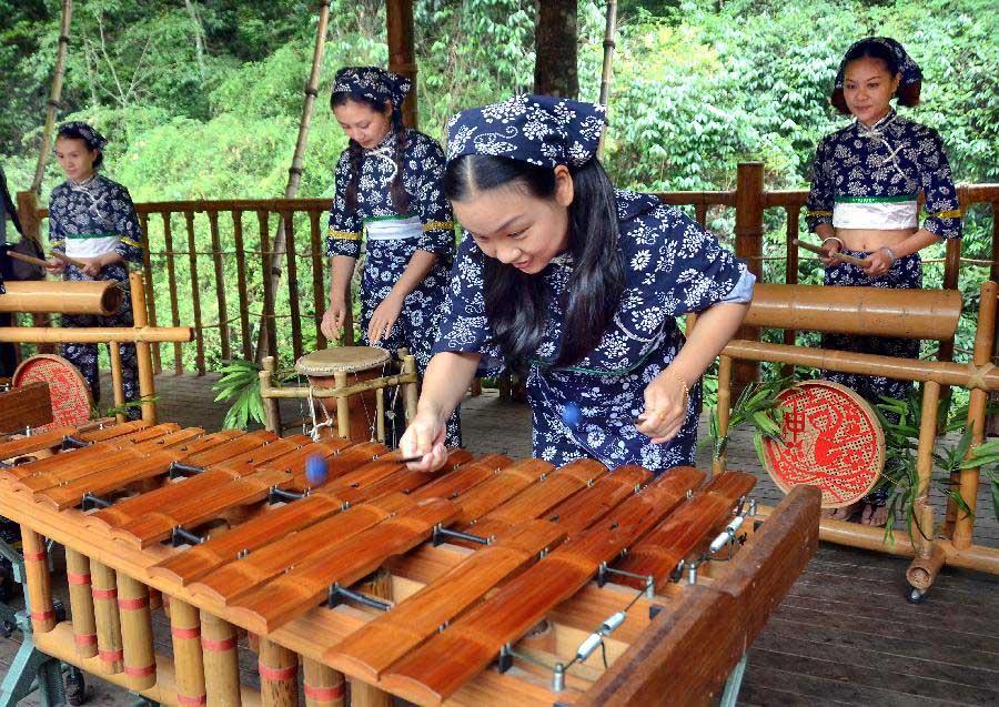 Bandswomen play musical instruments made with bamboo at the Lanxi Valley Rain Forest Scenic Area in Chongyi County, east China's Jiangxi Province, May 28, 2013. Chongyi boasts of abundant resources of moso bamboo. (Xinhua/Wang Song) 