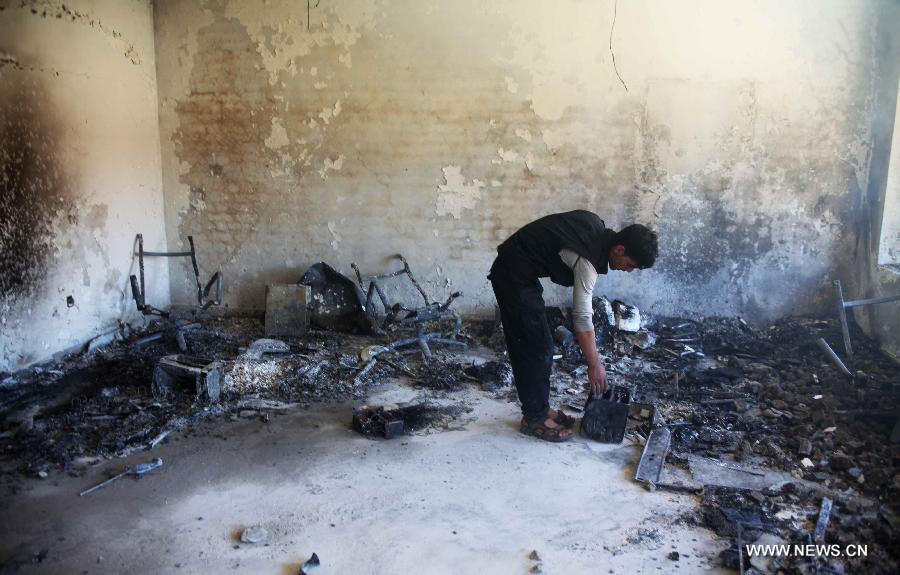 An Afghan policeman works at the suicide attack site on Panjshir governor compound in Panjshir province, Afghanistan, on May 29, 2013. One policeman and six militants were killed early Wednesday morning when Taliban suicide bombers launched an attack on the provincial governor office building in eastern Afghan province of Panjshir, a provincial source said. (Xinhua/Ahmad Massoud) 