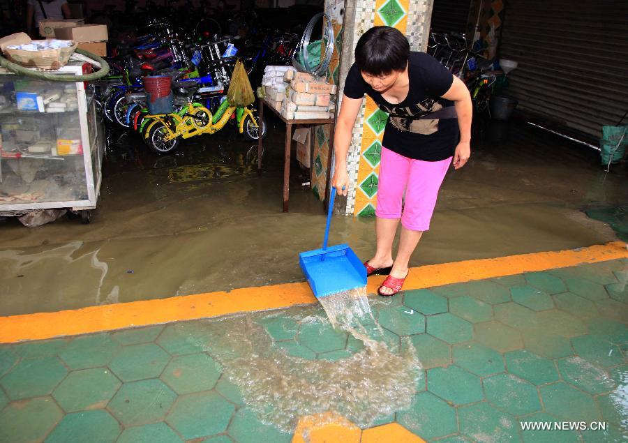 A woman cleans her flooded shop in Fengshan County, south China's Guangxi Zhuang Autonomous Region, May 29, 2013. Fengshan County was hit by the heaviest rainfall of the year on Wednesday morning. (Xinhua/Zhou Enge) 