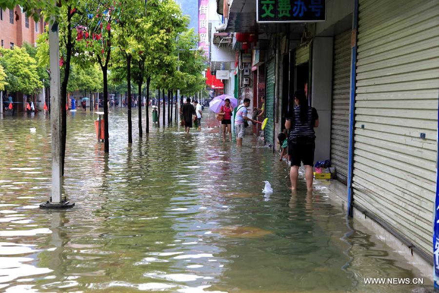 Photo taken on May 29, 2013 shows shops closed down after the rainfall in Fengshan County, south China's Guangxi Zhuang Autonomous Region. Fengshan County was hit by the heaviest rainfall of the year on Wednesday morning. (Xinhua/Zhou Enge)