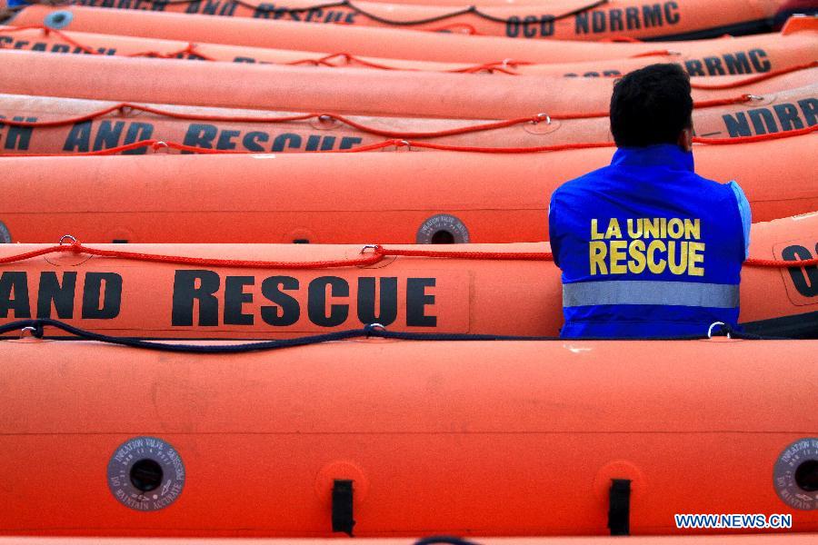 A member of provincial rescue personnel prepares the rigid hull inflatable boats in Camp Aguinaldo in Quezon City, the Philippines, May 30, 2013. The Philippine National Disaster Risk Reduction and Management Council distributed multiple rigid hull inflatable boats and other rescue equipments to flood and disaster-prone provinces in preparation for typhoons. (Xinhua/Rouelle Umali)