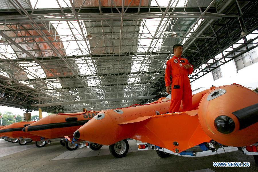 A member of provincial rescue personnel prepares the rigid hull inflatable boats in Camp Aguinaldo in Quezon City, the Philippines, May 30, 2013. The Philippine National Disaster Risk Reduction and Management Council distributed multiple rigid hull inflatable boats and other rescue equipments to flood and disaster-prone provinces in preparation for typhoons. (Xinhua/Rouelle Umali)