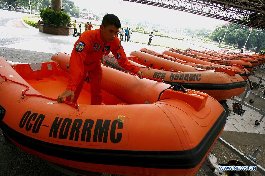 A member of provincial rescue personnel prepares the rigid hull inflatable boats in Camp Aguinaldo in Quezon City, the Philippines, May 30, 2013. The Philippine National Disaster Risk Reduction and Management Council distributed multiple rigid hull inflatable boats and other rescue equipments to flood and disaster-prone provinces in preparation for typhoons. (Xinhua/Rouelle Umali)