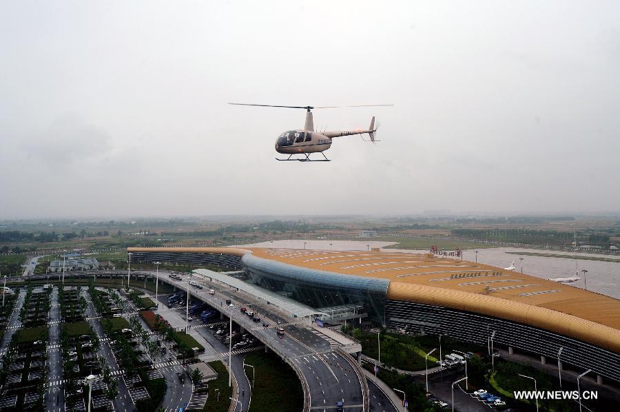 A helicopter takes photo of the general view of the Hefei Xinqiao International Airport, east China's Anhui Province, May 30, 2013. Located in Gaoliu Town of Feixi County, 31.8 kilometers away from the center of Hefei City, Xinqiao International Airport has replaced Luogang International Airport as Hefei's main airport. (Xinhua/Ma Qibing)