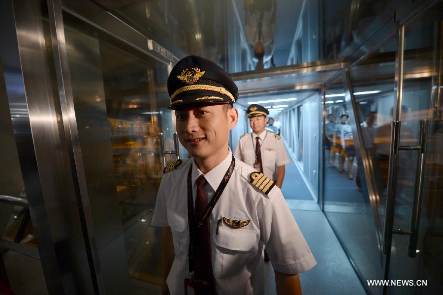 The captain of the first plane arriving at the Hefei Xinqiao International Airport walks out of the channel, east China's Anhui Province, May 30, 2013. Located in Gaoliu Town of Feixi County, 31.8 kilometers away from the center of Hefei City, Hefei Xinqiao International Airport has replaced Luogang International Airport as Hefei's main airport. (Xinhua/Zhang Duan)