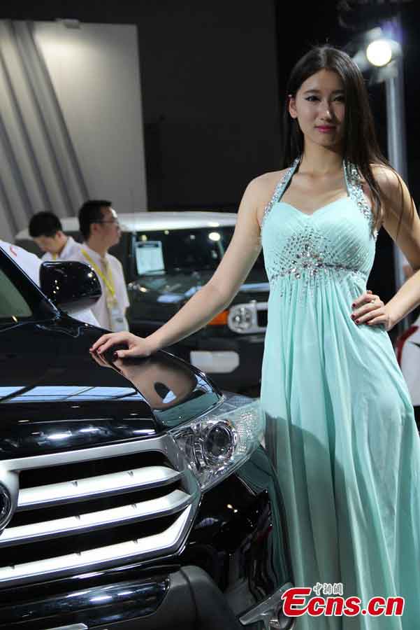A model presents a car at the 2013 Asia-Europe International Auto Show at the International Exhibition Center in Urumqi, capital of Northwest China's Xinjiang Uygur Autonomous Region, May 29, 2013. (CNS/Yang Zhe)