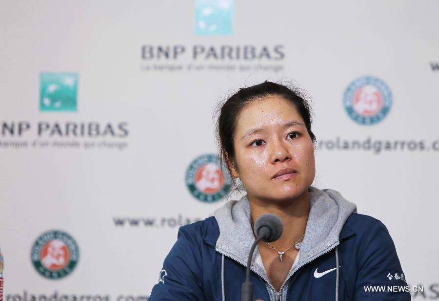 Li Na of China reacts during the news conference after the women's singles second round match against Bethanie Mattek Sands of the United States at the French Open tennis tournament at the Roland Garros stadium in Paris, France, May 30, 2013. Li Na lost the match 1-2. (Xinhua/Gao Jing)