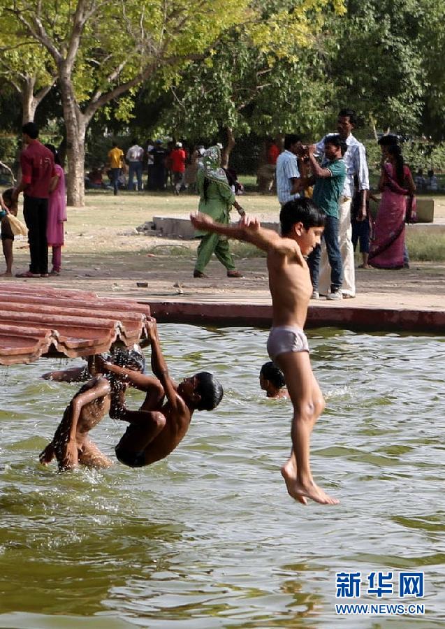 Several children enjoy themselves in a pool in New Delhi, India, June 19, 2012. (Photo/Xinhua)