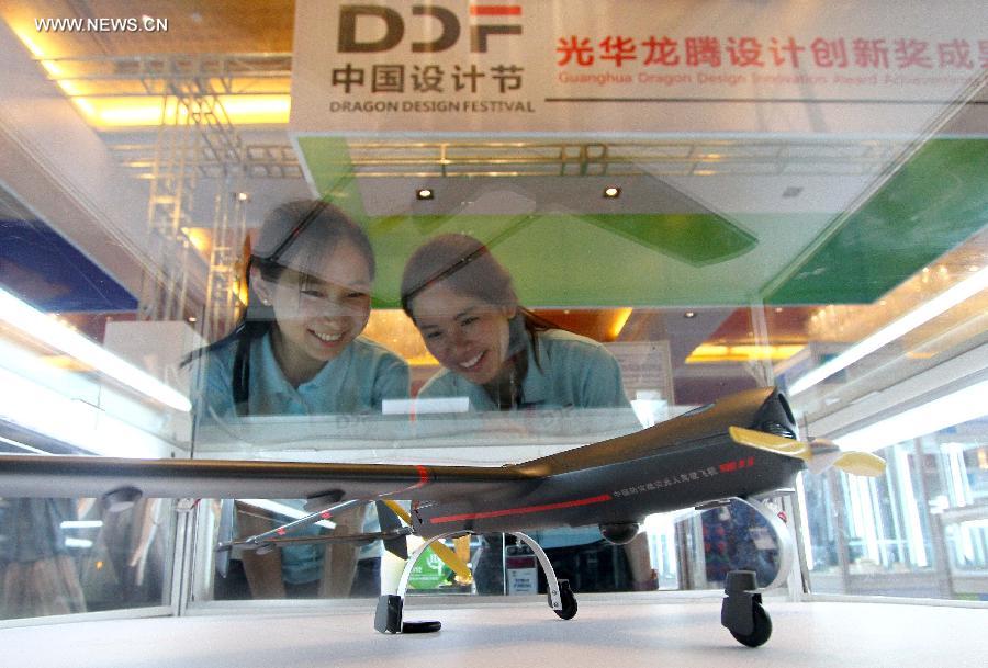 Visitors view the model of pilotless aircraft at the China Design Festival in Beijing, capital of China, May 29, 2013. The China Design Festival, which kicked off on May 30, will last until June 1. (Xinhua)