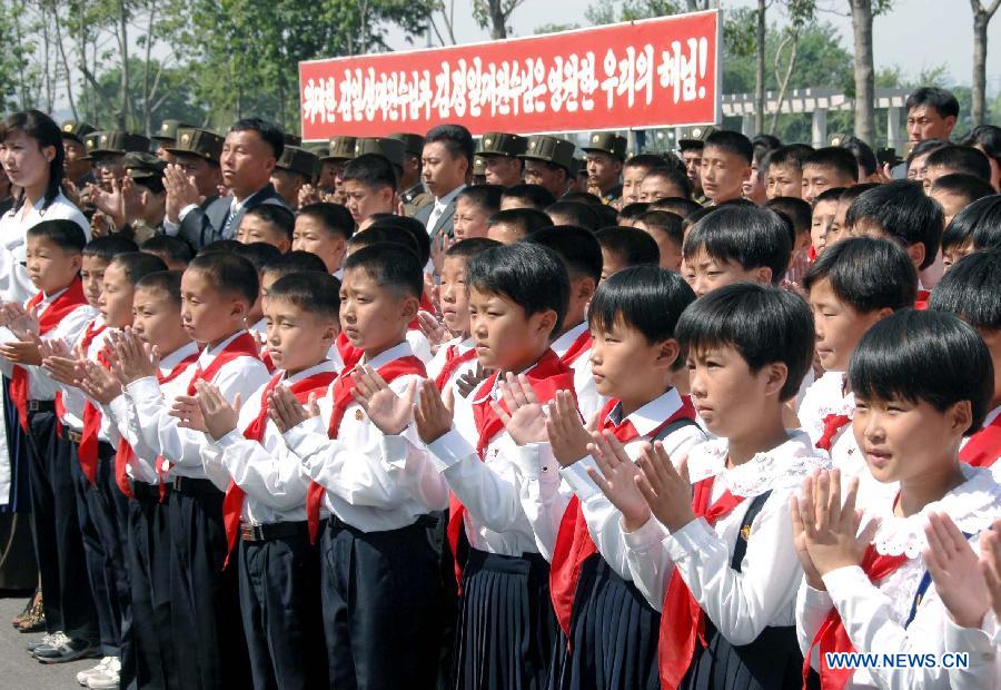 The photo provided by KCNA on May 31, 2013 shows children from the Songdowon International Children's Camp welcoming top leader of the Democratic People's Republic of Korea (DPRK) Kim Jong Un (not pictured) in Kangwon province, DPRK, on May 30, 2013. (Xinhua/KCNA) 