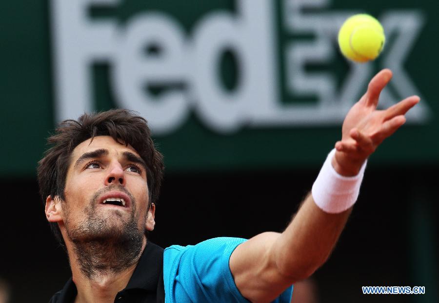 Jeremy Chardy of France serves during men's singles third round match against his compatriot Jo-Wilfried Tsonga at the French Open tennis tournament at the Roland Garros stadium in Paris, France, May 31, 2013. Tsonga won 3-0. (Xinhua/Gao Jing) 
