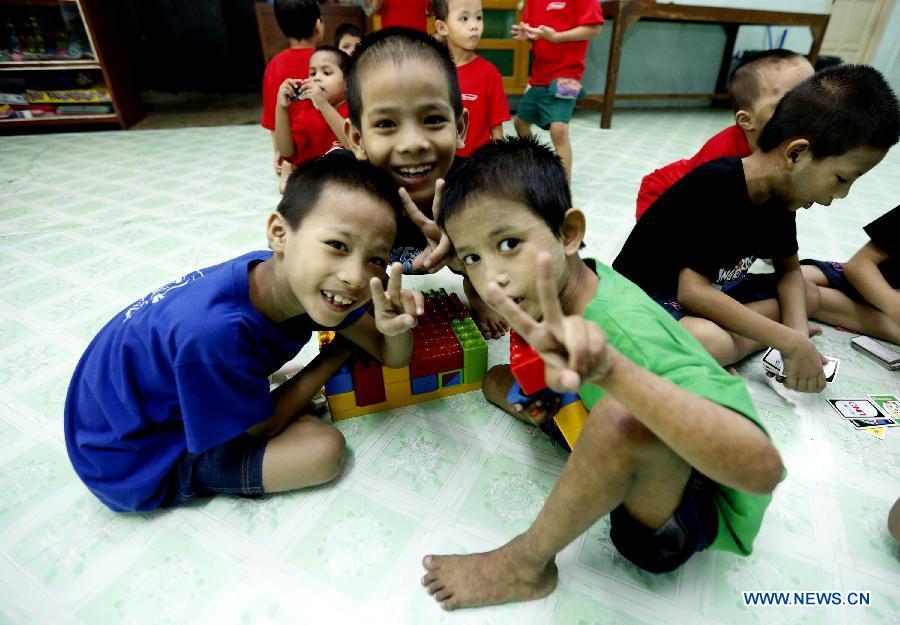 Children play on the International Children's Day at a residential nursery in Yangon, Myanmar, June 1, 2013. The residential nursery was established in 1952 by Myanmar's Ministry of Social Welfare, Relief and Resettlement, caring for abandoned children, orphans and socially or economically disadvantaged children. (Xinhu/U Aung)