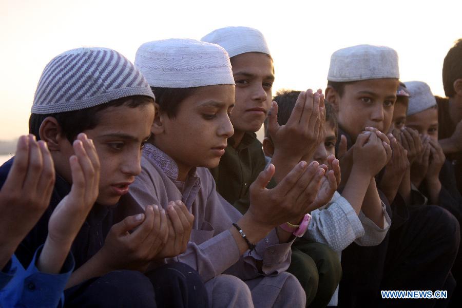 Pakistani boys pray at a local seminary on International Children's Day in eastern Pakistan's Lahore, June 1, 2013. The International Children's Day was observed in the country on Saturday, with non-governmental organizations and schools promoting international fraternity and harmony among children from different backgrounds, as well as equal rights for every child. (Xinhua/Jamil Ahmed)