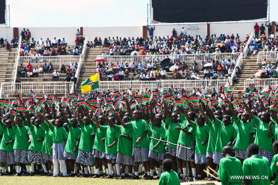 Kenyan children chorus during a military parade to celebrate the 50th Madaraka Day in Nairobi, capital of Kenya, June 1, 2013. Kenya formed its self-government and attained the right to manage its own affairs from British colonialists on June 1, 1963. (Xinhua/Meng Chenguang) 

