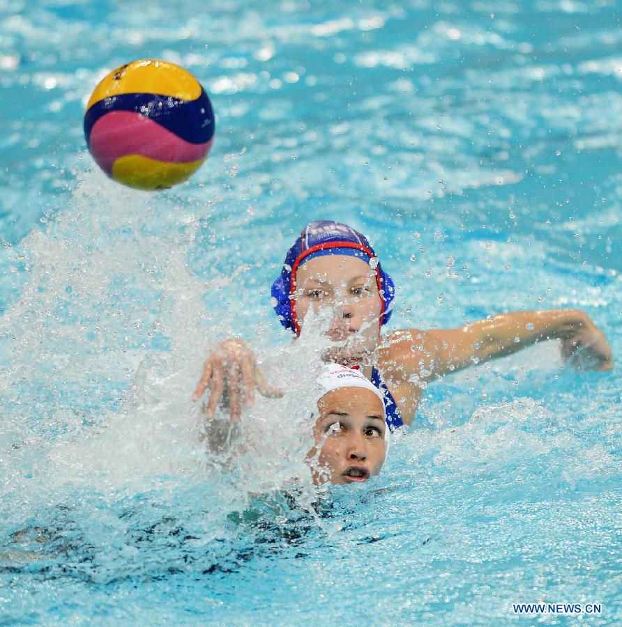 Evgeniya Ivanova (back) of Russia vies for the ball during their match against Hungary at the 2013 FINA Women's Water Polo World League Super Final in Beijing, capital of China, June 1, 2013. Russia lost 10-11. (Xinhua/Tao Xiyi) 