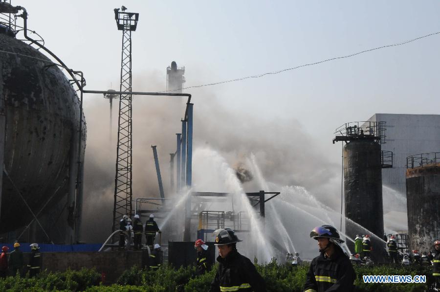 Fire fighters put out a fire at the accident site of oil residue tank blasts in a PetroChina outlet in Dalian, northeast China's Liaoning Province, June 2, 2013. At least two people were injured and two others have been reported missing after two tanks containing residual diesel oil exploded around 2:20 p.m. The cause of the blast is under investigation. (Xinhua/Cai Yongjun)