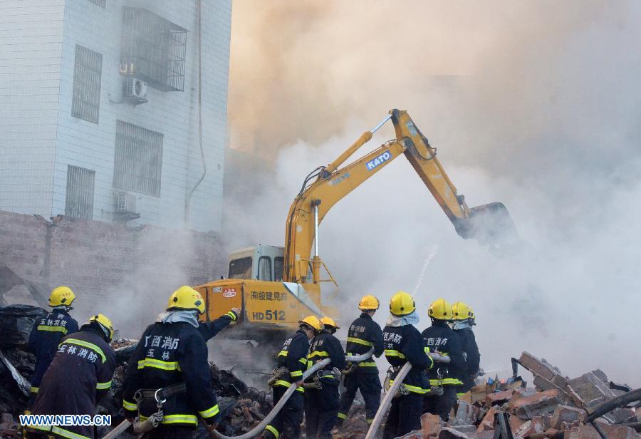 Firemen spray water at the scene of a fire at Daxin Village in Yulin City, south China's Guangxi Zhuang Autonomous Region, early June 2, 2013. The fire broke out at a storehouse early Sunday and was put out after hours by local fire department. The fire burned an area of some 3,000 square meters, with no casualties reported. (Xinhua/Wei Gongbing)