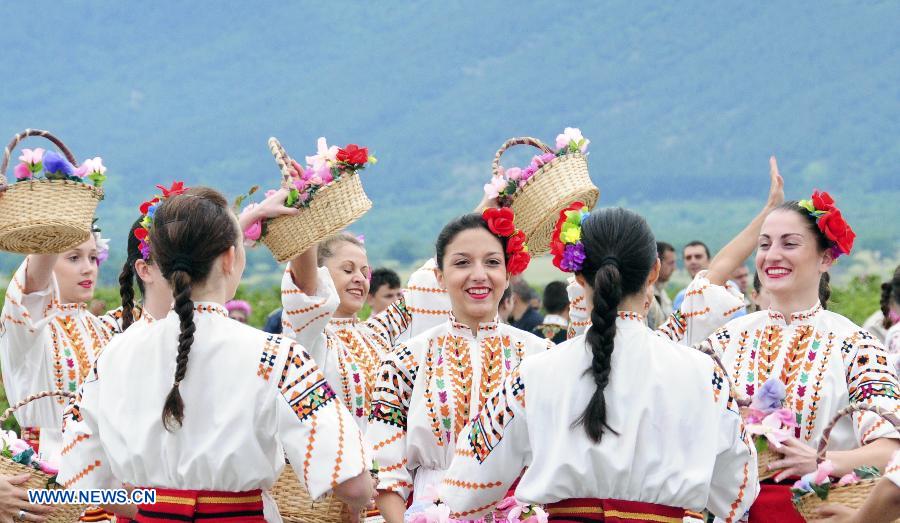 Bulgarian girls dance during the Rose Festival in the Kazanlak city, the center of Bulgaria's Rose Valley, June 2, 2013. The Rose Festival was held in Kazanluk on Sunday, with activities including rose picking, dance performances and parade after the election of the Rose Queen. Bulgaria is one of the biggest producers of rose oil in the world. (Xinhua/Chen Hang)