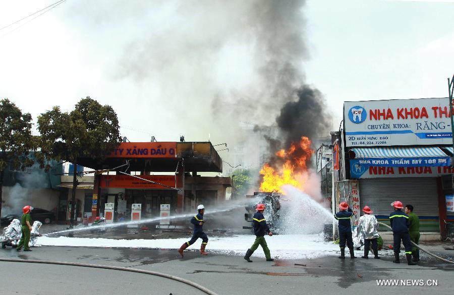 Firemen try to extinguish a fire occurred at a gas station in Hanoi, capital of Vietnam, June 3, 2013. The fire came from a gasoline truck and injured three staff members of the gas station. (Xinhua/VNA)