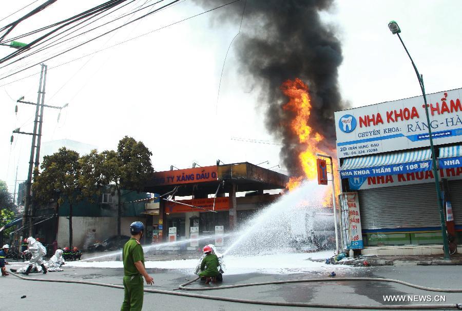 Firemen try to extinguish a fire occurred at a gas station in Hanoi, capital of Vietnam, June 3, 2013. The fire came from a gasoline truck and injured three staff members of the gas station. (Xinhua/VNA)