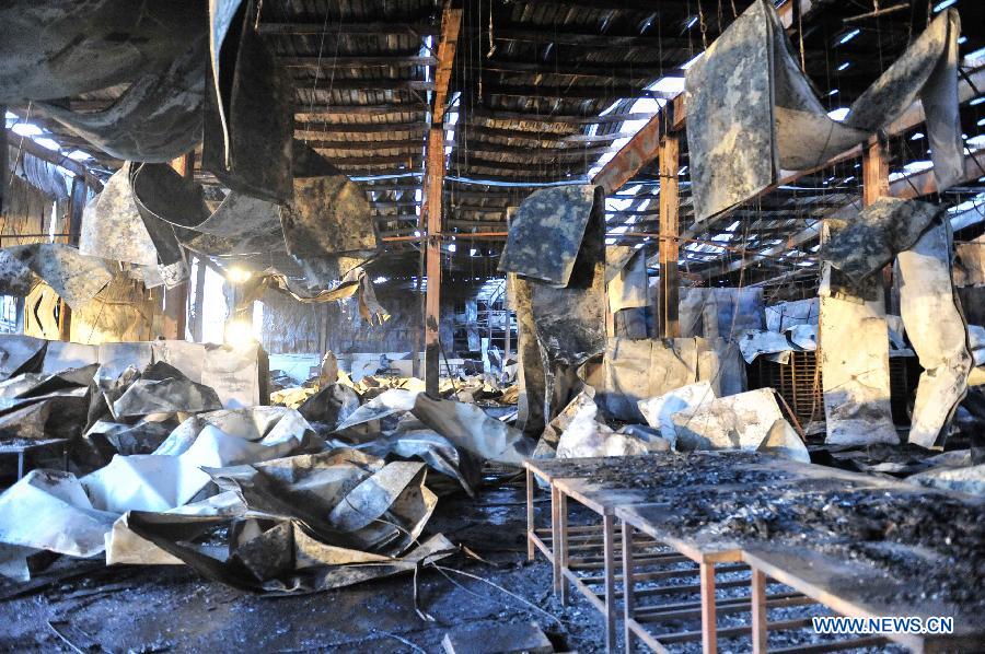 Photo taken on June 3, 2013 show the burnt poultry slaughterhouse owned by the Jilin Baoyuanfeng Poultry Company in Mishazi Township of Dehui City in northeast China's Jilin Province. The death toll from the fire has risen to 119 as of 8 p.m. on Monday. Search and rescue work is under way. (Xinhua/Wang Hao Fei)