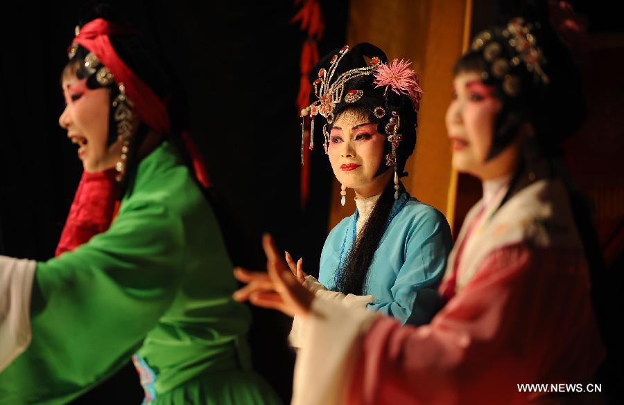 Actresses performs at the Chen's Garden Sichuan Opera Troupe in suburban Chengdu, capital of southwest China's Sichuan Province, June 1, 2013. Sichuan opera is one of the oldest forms of Chinese opera, distinguished by face-changing, fire-spitting and other stunts. Regionally Chengdu remains to be the main home of Sichuan opera, while other influential locales include Yunnan, Guizhou and other provinces in southwest China. (Xinhua/Xue Yubin) 