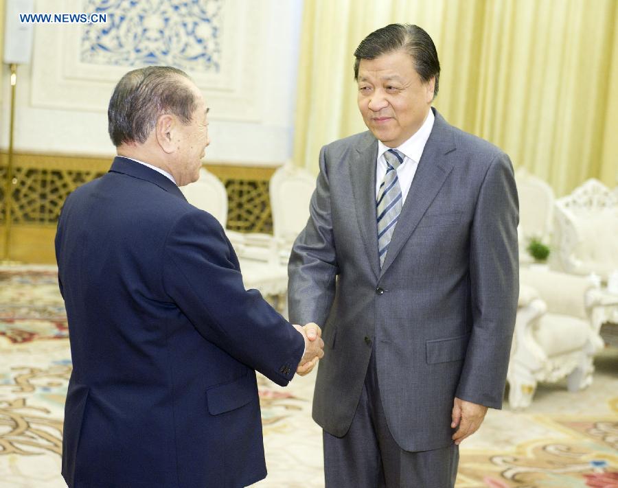 Liu Yunshan (R), a member of the Standing Committee of the Political Bureau of the Communist Party of China Central Committee, shakes hands with Hiromu Nonaka, former secretary-general of the Liberal Democratic Party, who leads a delegation of senior Japanese politicians, in Beijing, capital of China, June 3, 2013. (Xinhua/Huang Jingwen) 
