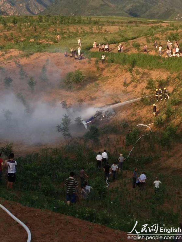 A police helicopter of the public security bureau of Xi'an, capital city of northwest China’s Shaanxi province, crashes near a village in Lantian county around 6 p.m. on June 3, 2013, killing two people and injuring one. (Photo/CFP)