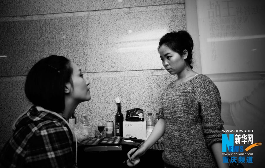 Tang Ling help the actors make up. This is her part-time job in the club; she also serves as stage manager. (Photo/Xinhua)