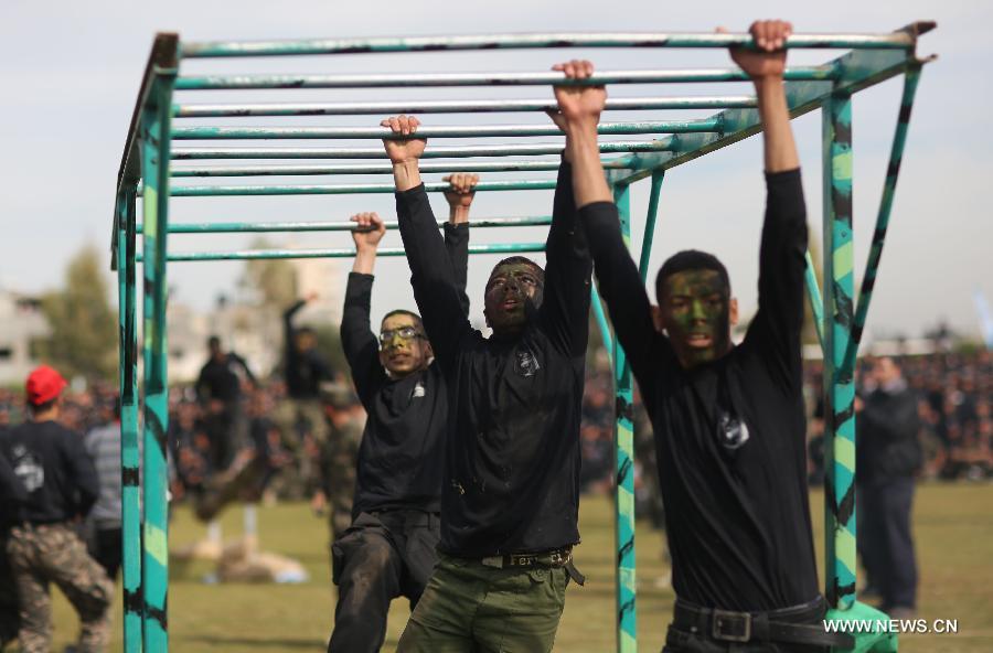 Palestinian high school students show their skills during a graduation ceremony of a military school course organized by the Hamas security forces and the Hamas Minister of Education in Gaza City, on Jan. 24, 2013. (Xinhua/Wissam Nassar)  