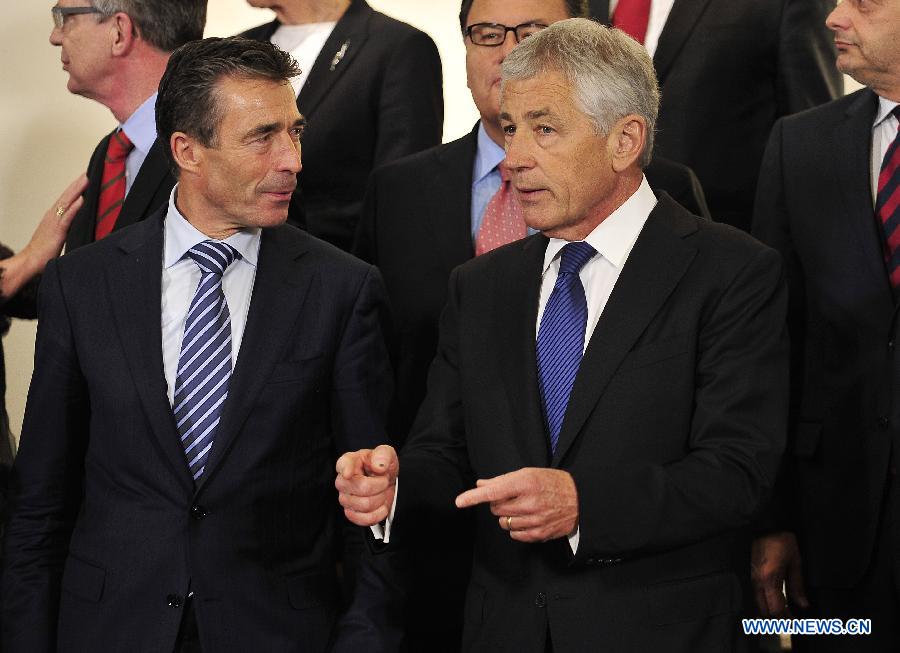 NATO Secretary General Anders Fogh Rasmussen (L) talks with United States Secretary of Defense Chuck Hagel during a photo session of a NATO Defense Minister Meeting at its headquarters in Brussels, capital of Belgium, June 4, 2013. NATO defense ministers convened on Tuesday to examine cyber security as a collective defense issue amid mounting concerns over the threat posed by cyber attacks. (Xinhua/Ye Pingfan)