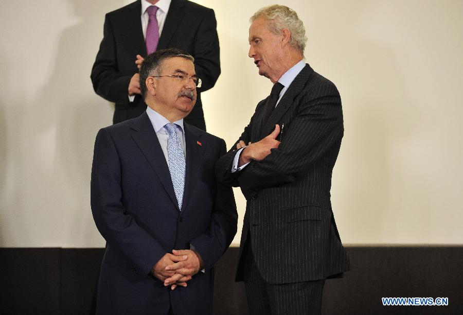 Turkish Defence Minister Ismet Yilmaz (L) talks with Spanish Secretary of Defense Pedro Morenes Eulate during a photo session of a NATO Defense Minister Meeting at its headquarters in Brussels, capital of Belgium, June 4, 2013. NATO defense ministers convened on Tuesday to examine cyber security as a collective defense issue amid mounting concerns over the threat posed by cyber attacks. (Xinhua/Ye Pingfan)