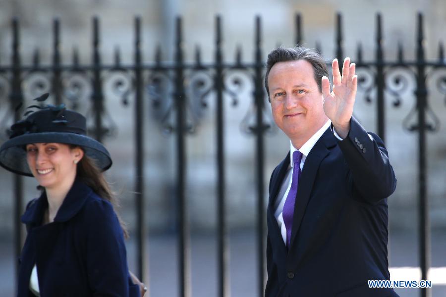 Britain's Prime Minister David Cameron (R) leaves Westminster Abbey after a ceremony celebrating the 60th anniversary of the Coronation of the Queen in London, capital of Britain, on June 4, 2013. (Xinhua/Yin Gang) 